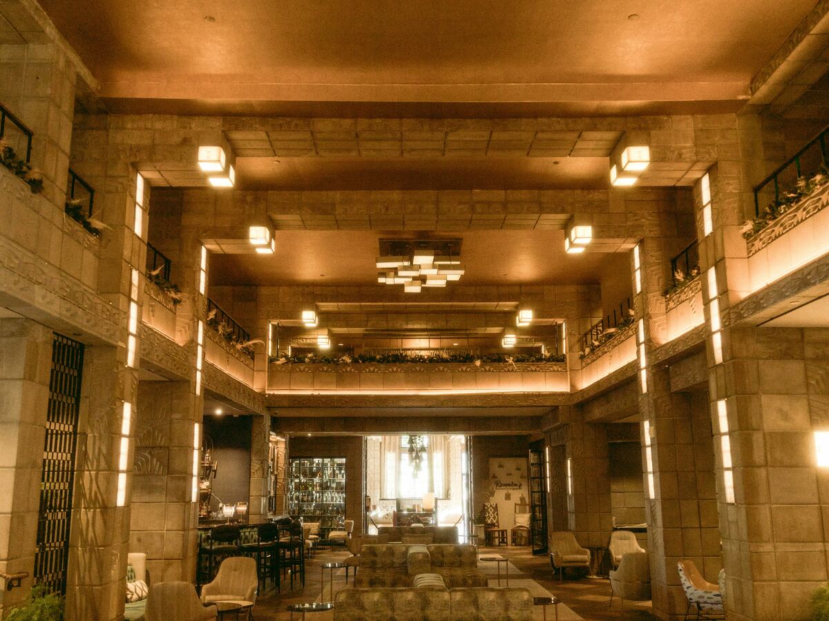 Grand hotel lobby with warm lighting and lounge seating